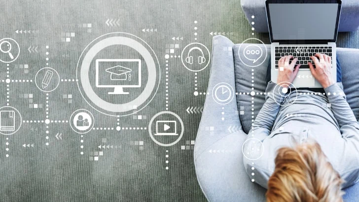 Overhead shot of person on laptop with abstract design with different icons superimposed