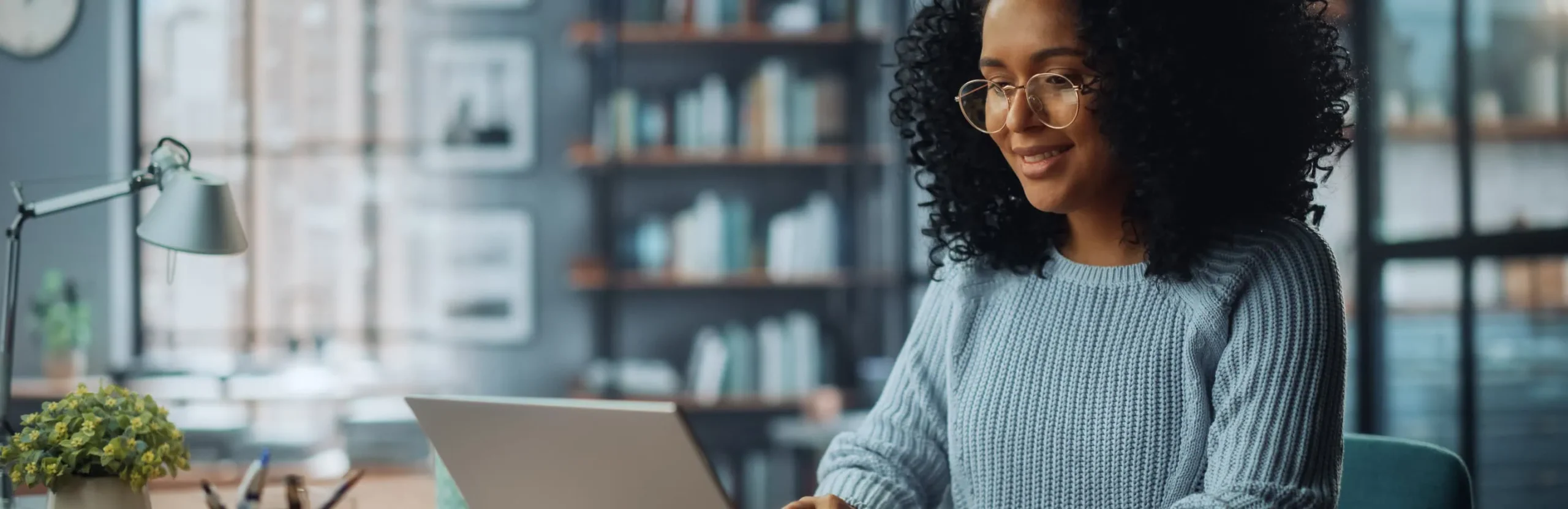 Woman smiling typing on computer